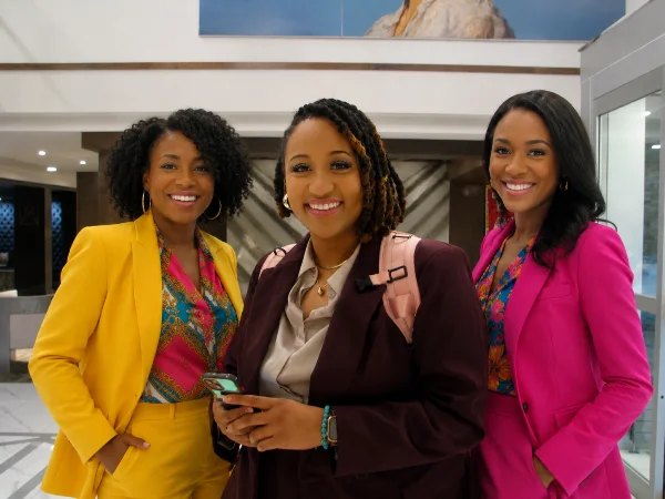 Three young professionals smiling together